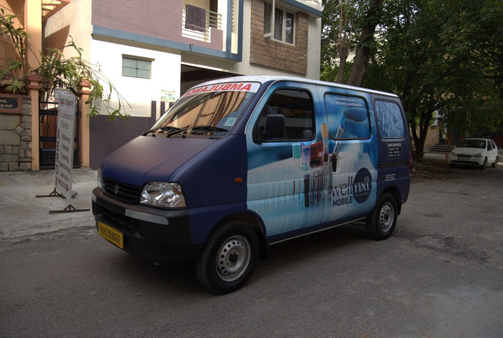 Wellnxt Lab on Wheels providing mobile diagnostic services at a residential area.